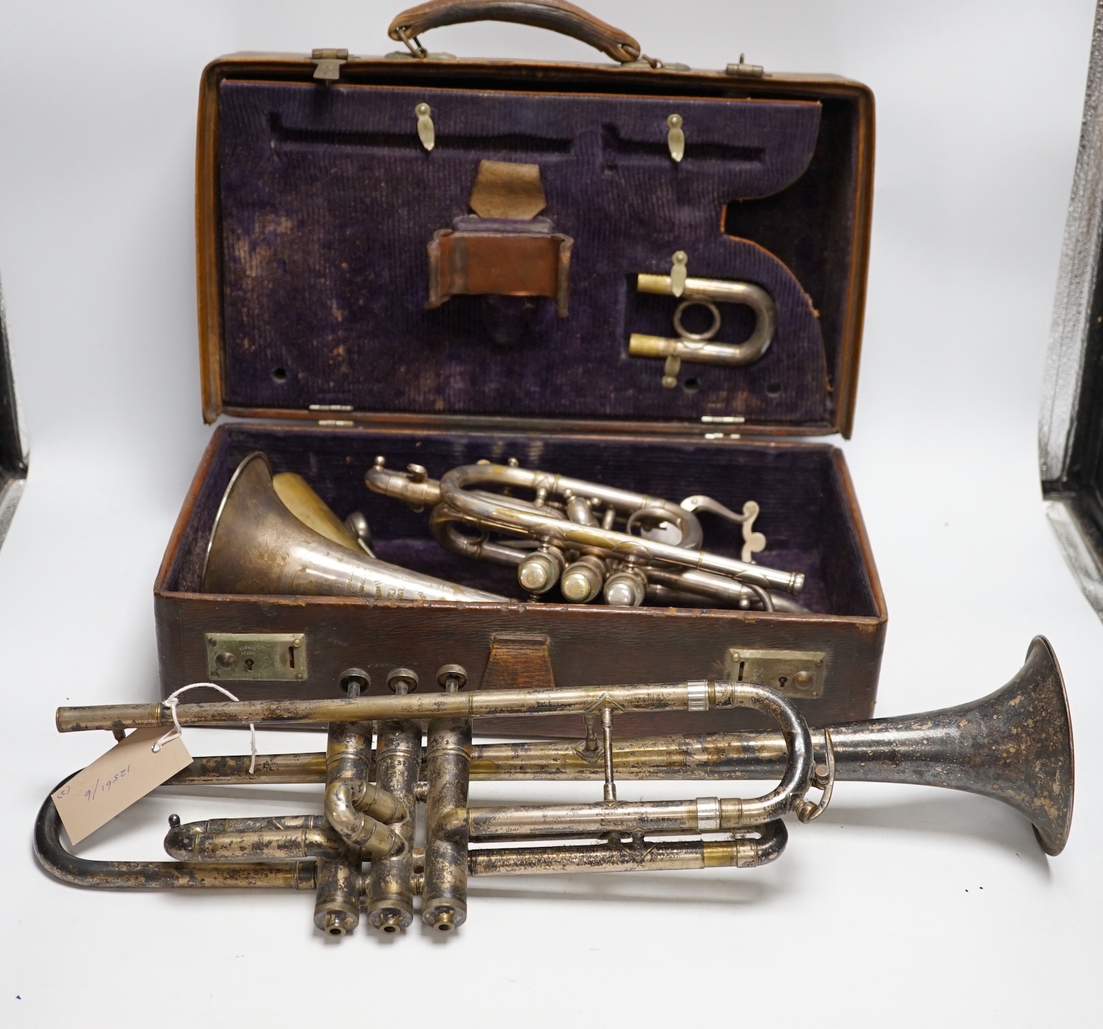A cased Hawkes & Son cornet, bell engraved with ‘Excelsior Soncrous Class A’ and an ‘American Standard High Grade’ trumpet, with a brass mute and three mouthpieces